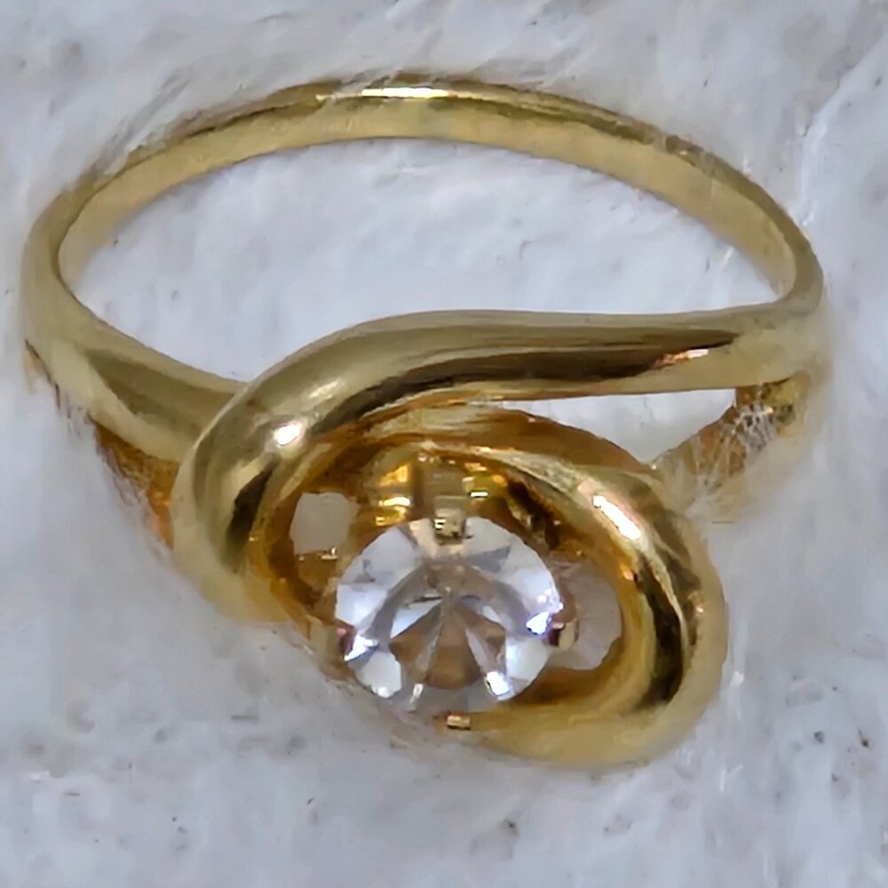 Size 7 Gold Tone Ring with a mounted Clear Stone